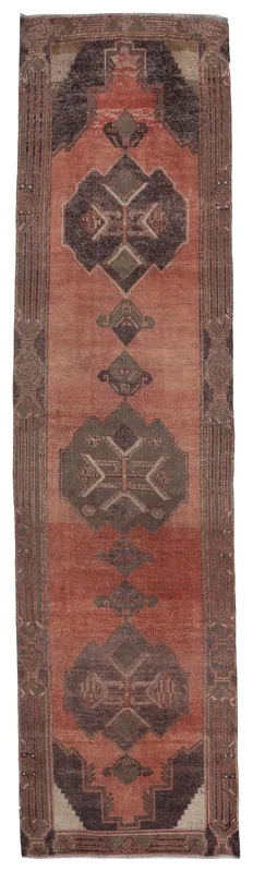 Full top view of the rust tribal geometric Anatolian runner rug on a white background