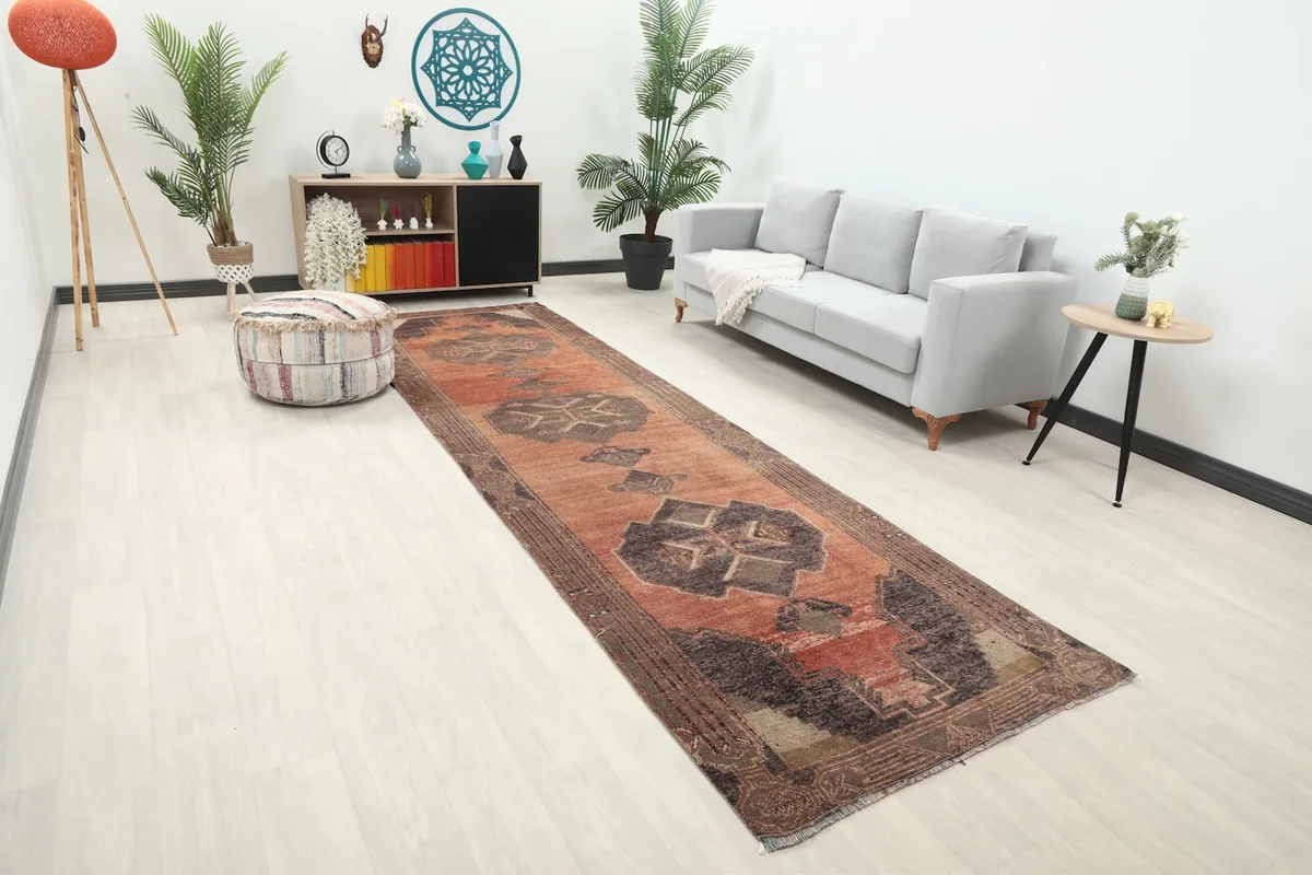 Angle view of the rust runner rug in a living room, showing its length and placement