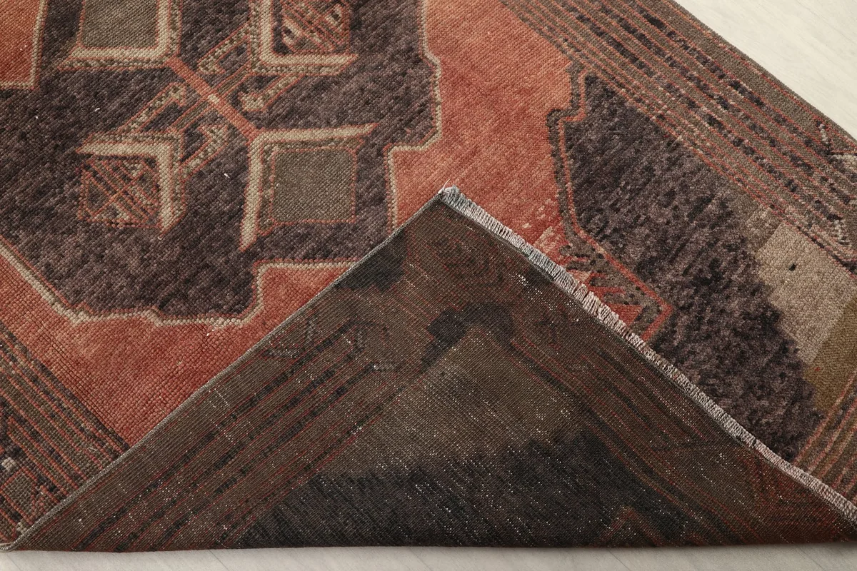 Underside view of the hand-knotted rug, revealing the cotton foundation and knotting