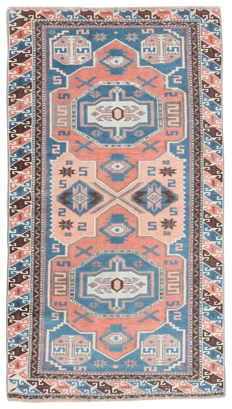 Full top view of the vintage Anatolian rug with rust and blue geometric patterns