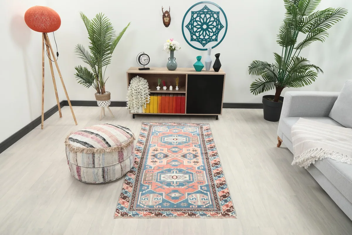 Vintage Anatolian rug in a living room setting with a light gray sofa and wooden cabinet