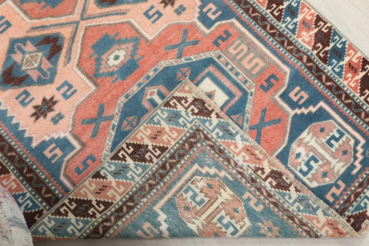 Corner of the rug folded back, revealing the wool pile and cotton foundation
