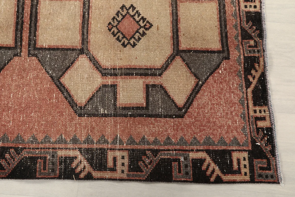 Close-up of the rust and beige geometric patterns and tribal border