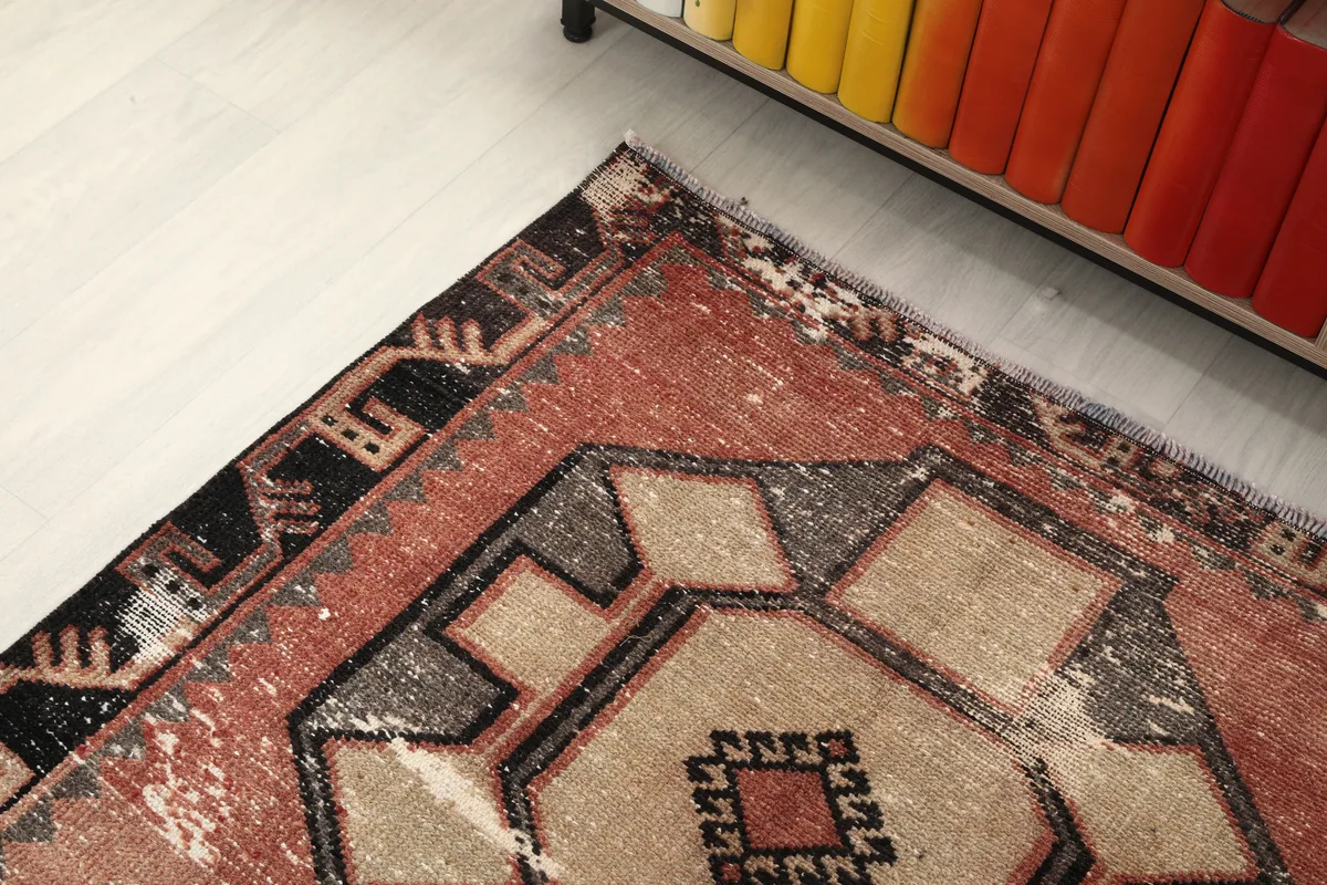 Corner detail of the runner showing the distressed patina and border design