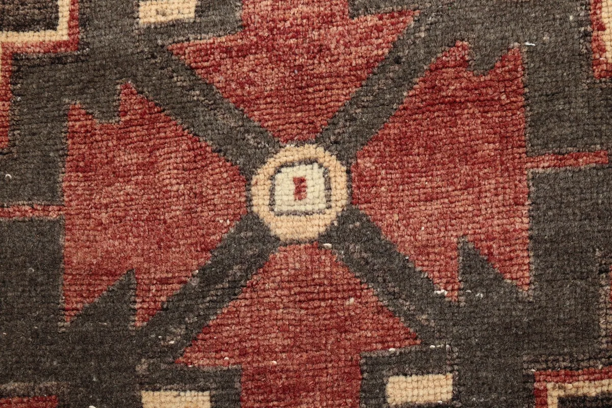 Extreme close-up of the wool pile showing texture and knots in the central motif