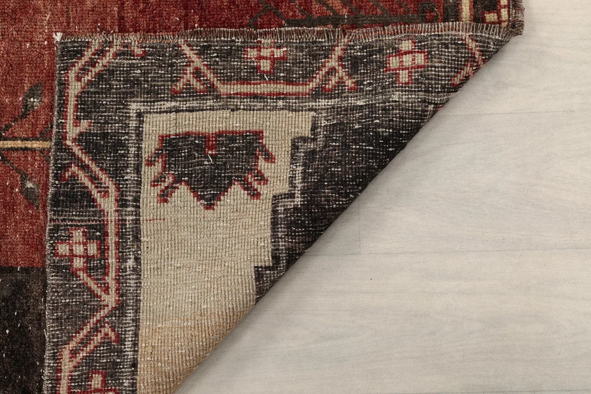 Another view of the rug's back, revealing the intricate hand-knotting and foundation