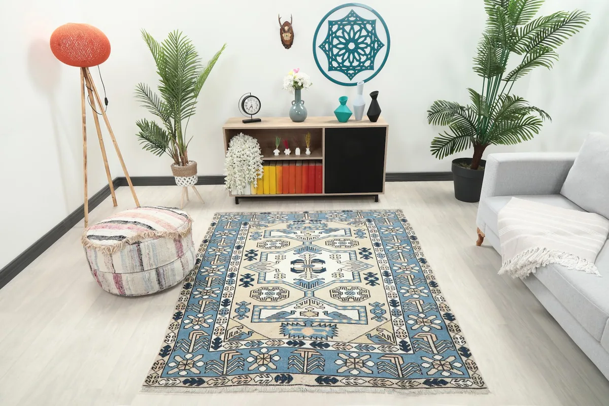 Vintage Anatolian rug displayed in a living room setting with a light couch and plants