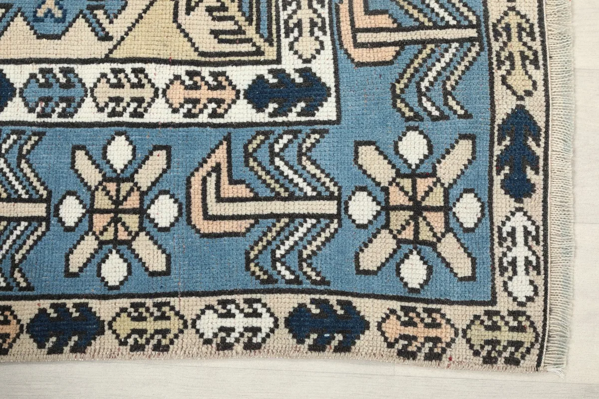 Detail of the blue border with intricate geometric and floral-like motifs