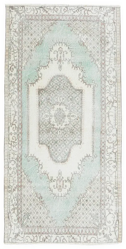 Full top view of the 4x6 vintage Anatolian rug with a green and ivory medallion pattern