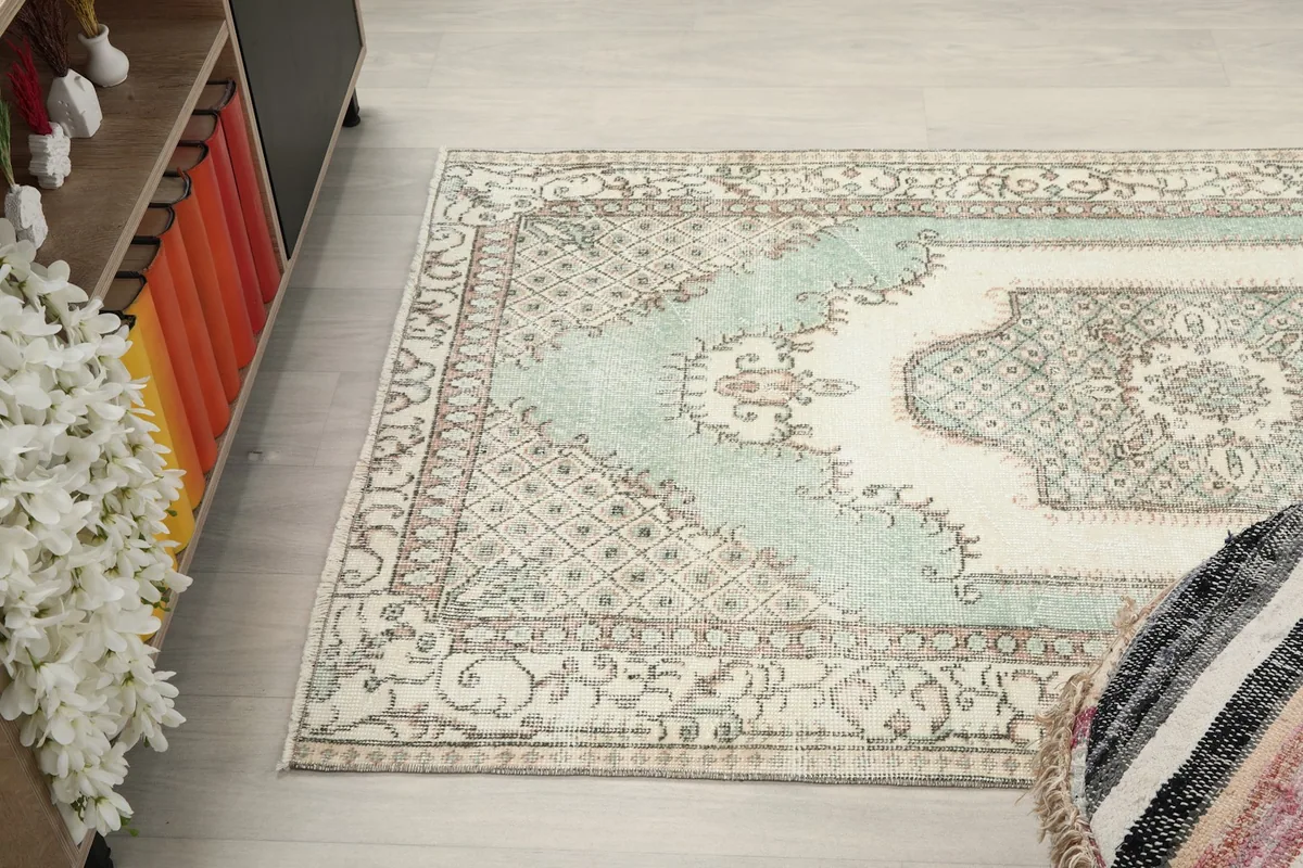 Angled view of the rug in the room, capturing its full length and patterns