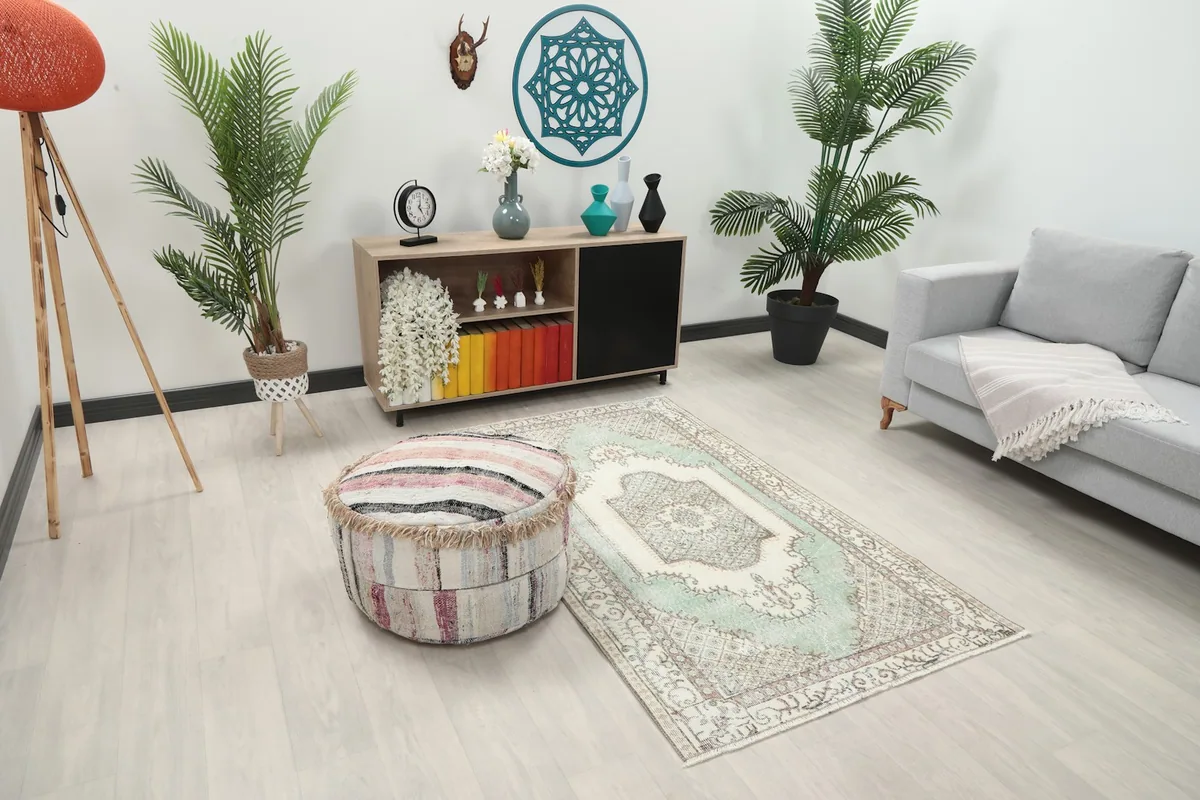 Angle view of the green and ivory area rug in a modern living space with furniture