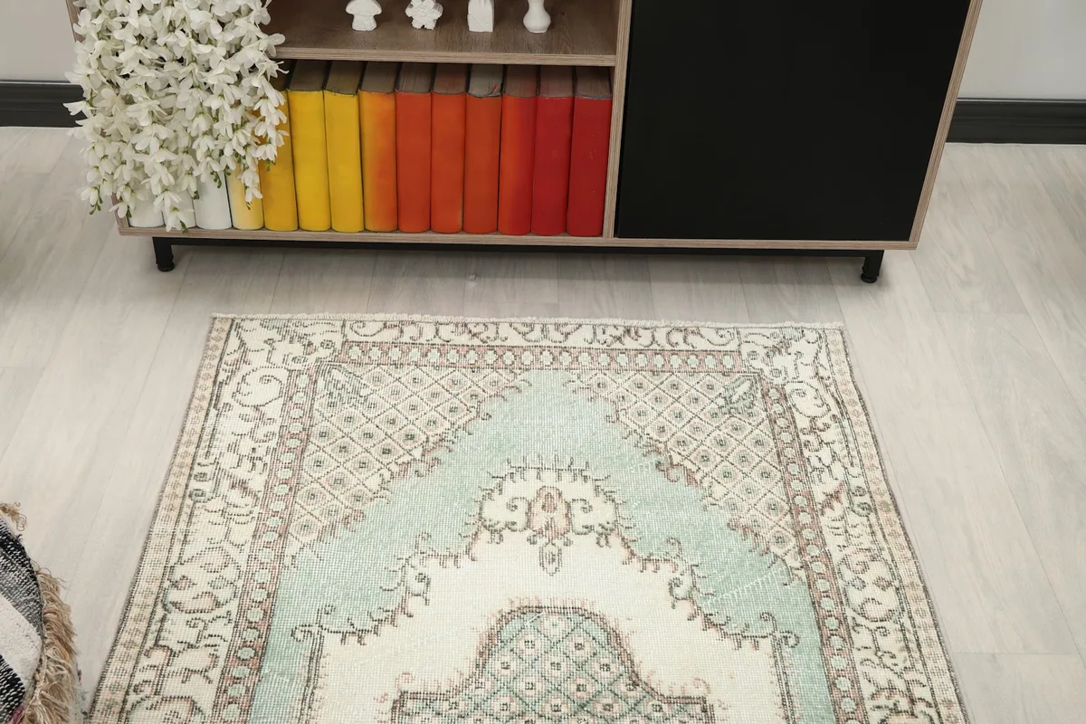 Overhead view of the vintage area rug from one end, showing its placement in the room