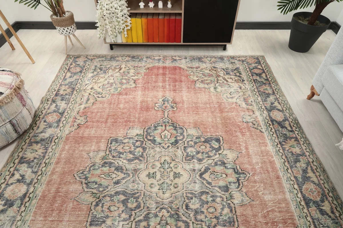 Overhead room view of the rose and navy rug in a bright, open living area