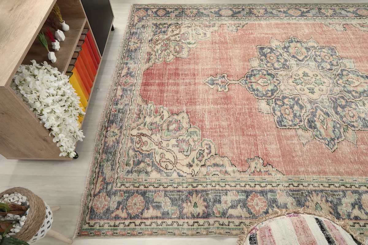 Wide angle view of the vintage rug extending under a console table in a living room