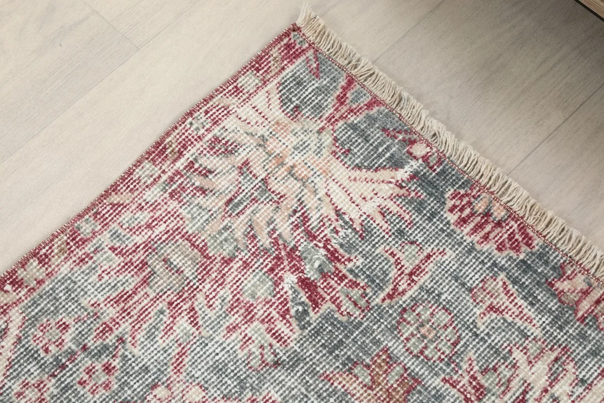 Detail of the rug's border area, showing the transition of colors and patterns