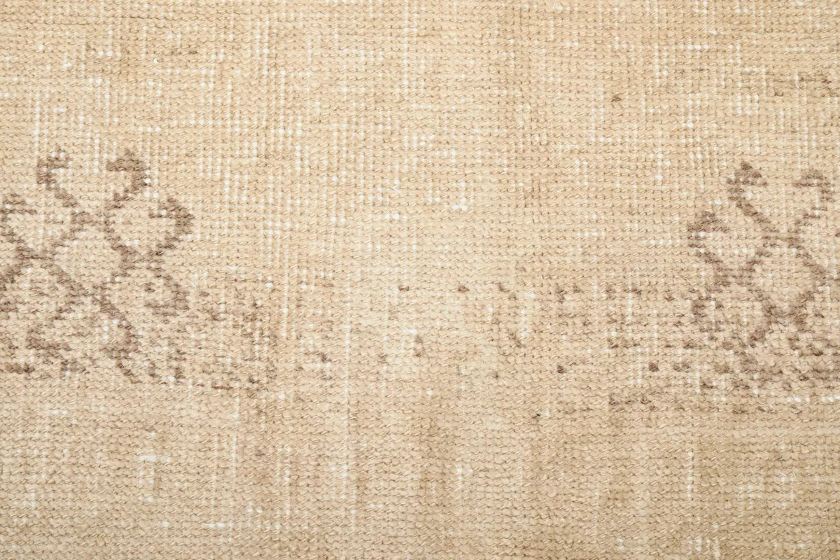 Detailed view of the distressed brown geometric tribal motifs across the runner's width