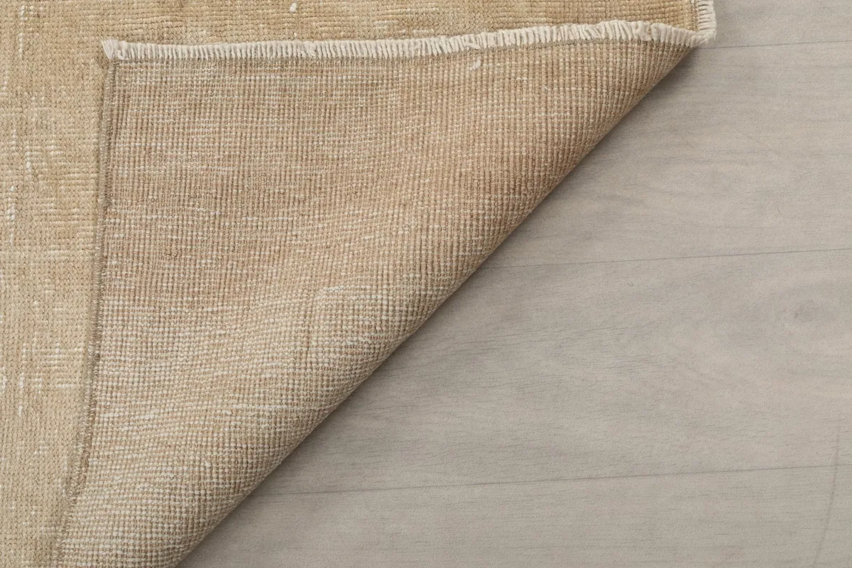 Angle view of the back of the hand-knotted wool on cotton vintage runner rug