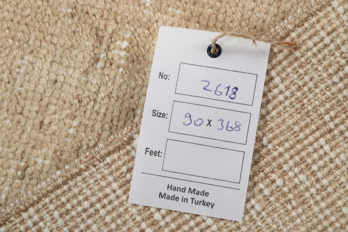Product tag showing the rug's dimensions 90x368 cm and 'Hand Made Made in Turkey'