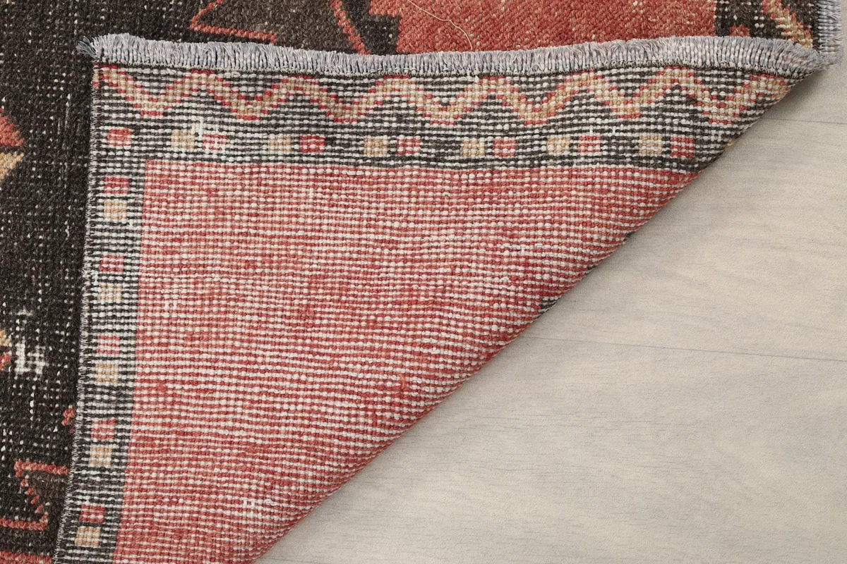 Another view of the rug's back, highlighting the density of the knots and the fringe detail.
