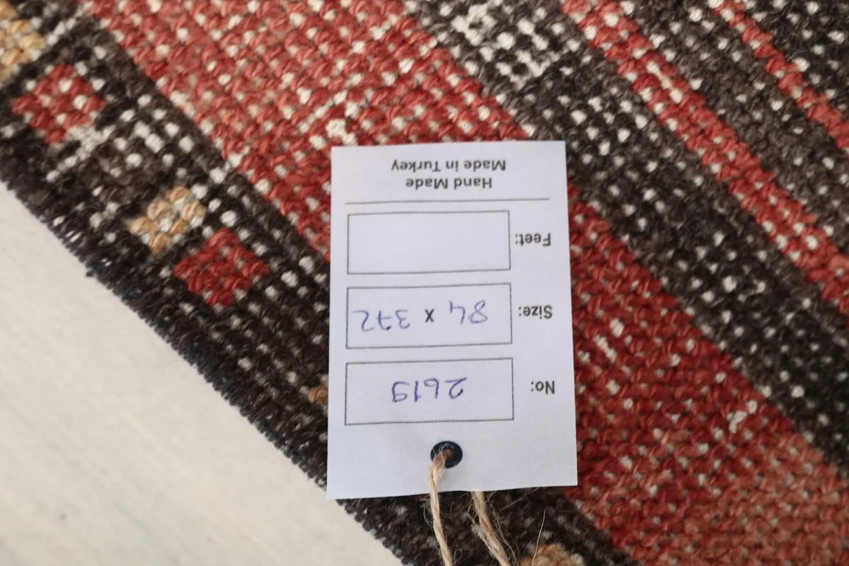 Tag on the back of the rug displaying its size 84x372 cm and confirming its hand-made origin in Turkey.