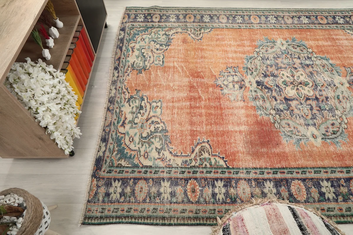 Wide angle view of the rug's surface, capturing the distressed texture and colors