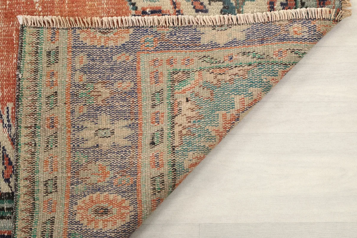 Underside view of the rug, revealing the tightly woven cotton foundation