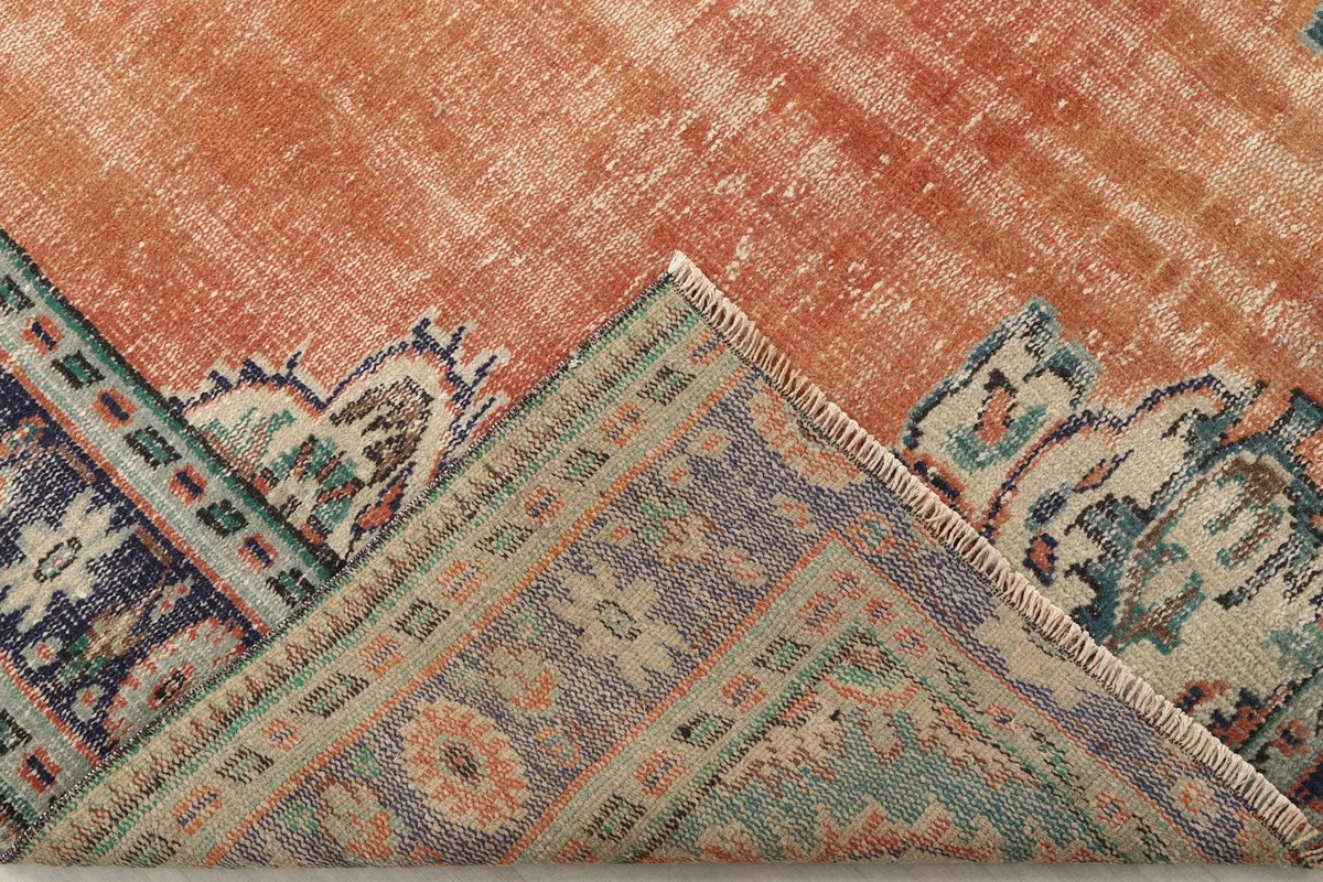 View of the rug folded to show the wool pile and cotton foundation construction