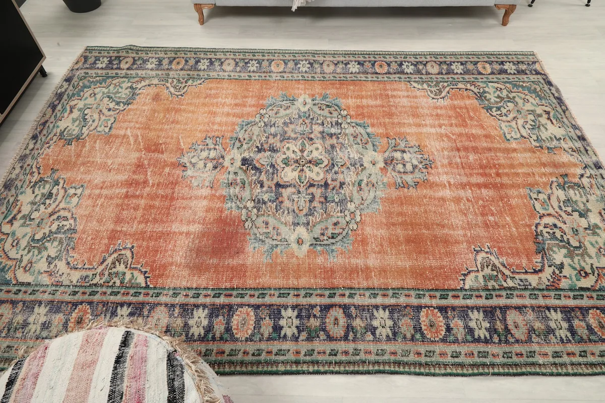 Full overhead view of the vintage rust rug, emphasizing its rectangular shape