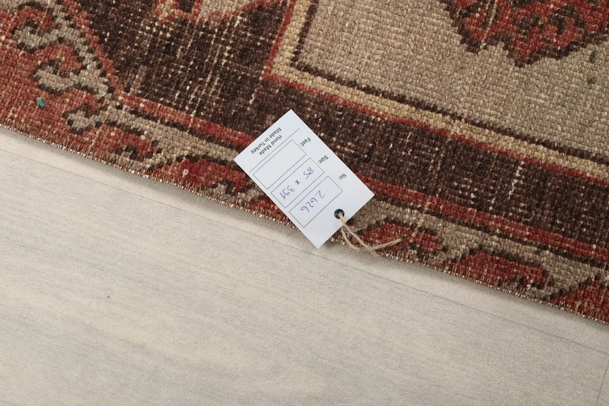 Close-up of the care tag attached to the vintage Anatolian runner