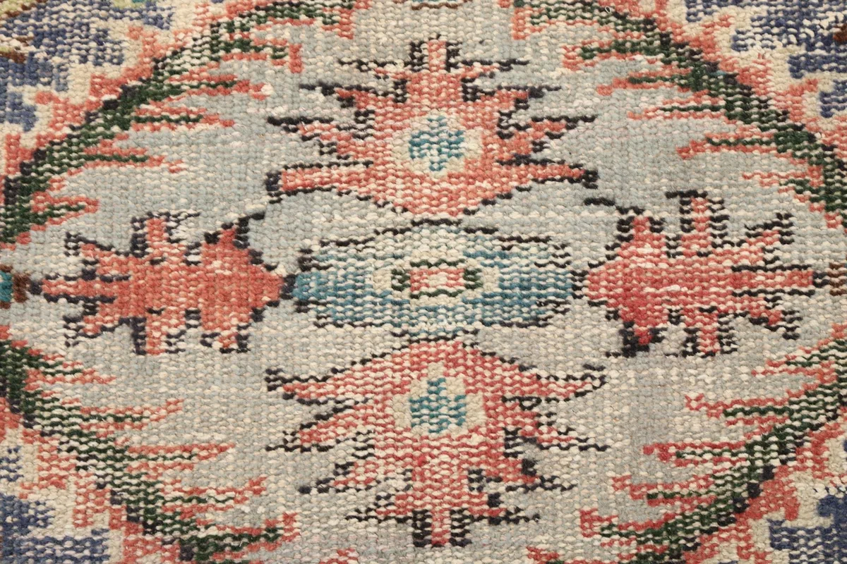 Close-up detail of the hand-knotted wool pile showing intricate patterns and texture