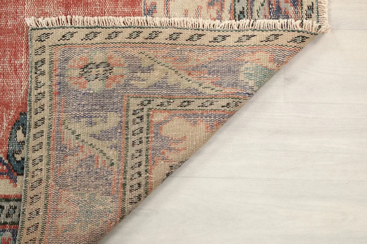 Detail of the rug's back showing the cotton foundation and hand-knotted construction