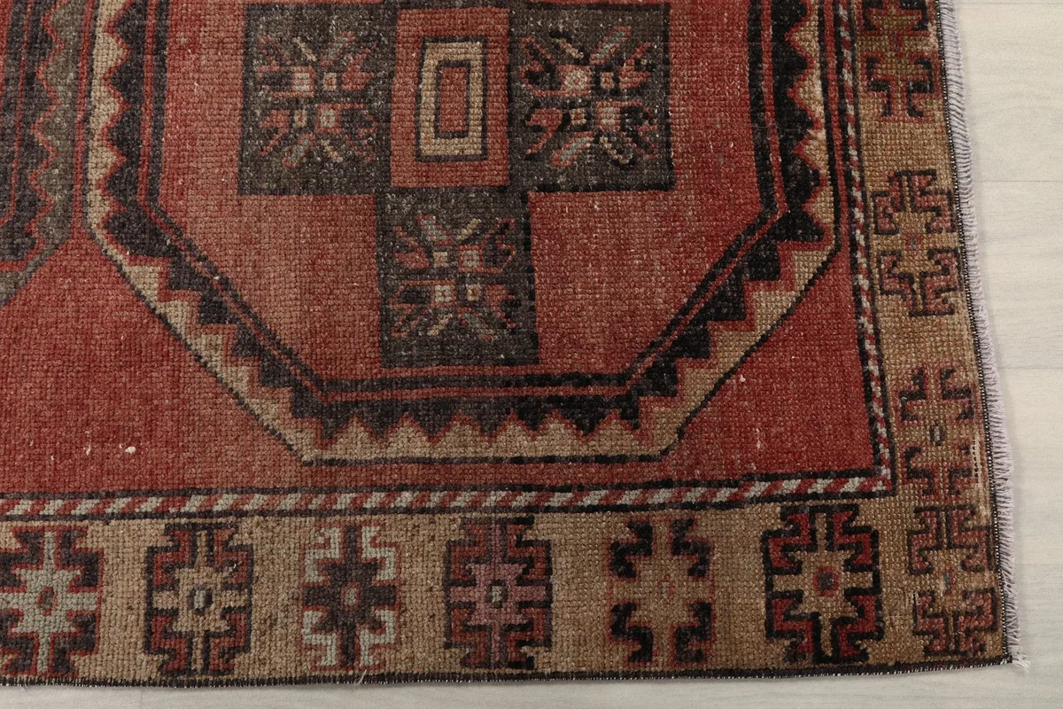 Detailed view of the rug's border and one octagonal motif, highlighting the beige and charcoal colors