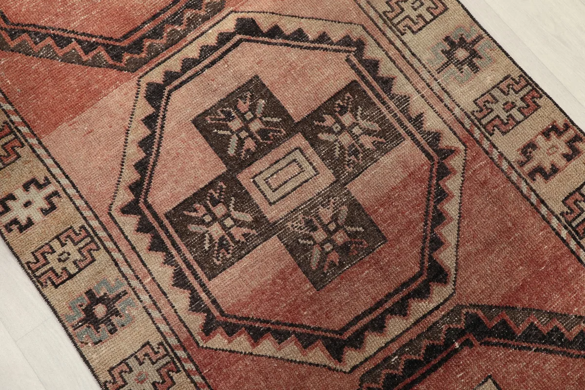 Close-up of a central octagonal medallion with intricate charcoal and rust patterns
