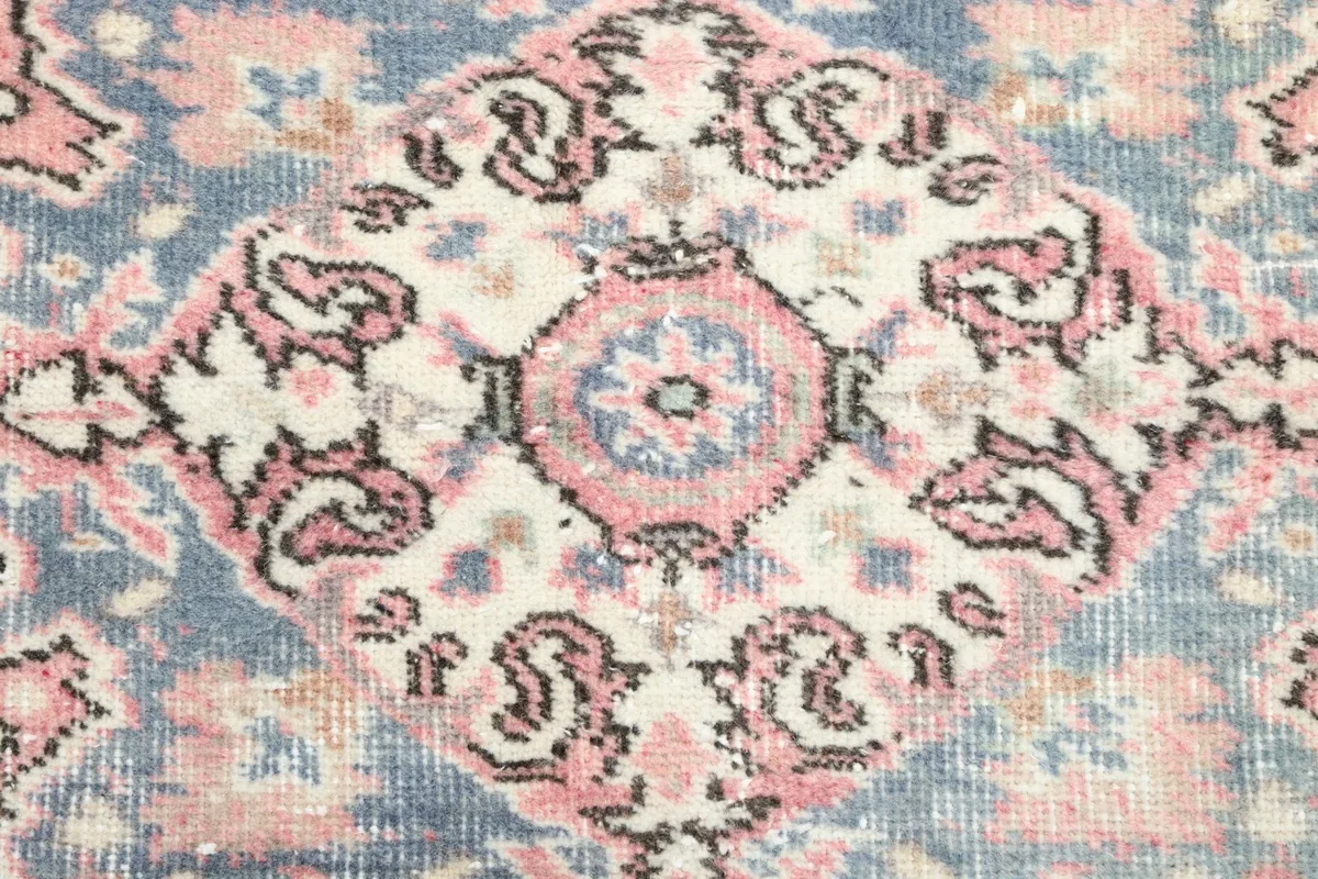 Close-up of the central blue medallion with its intricate design and subtle color variations