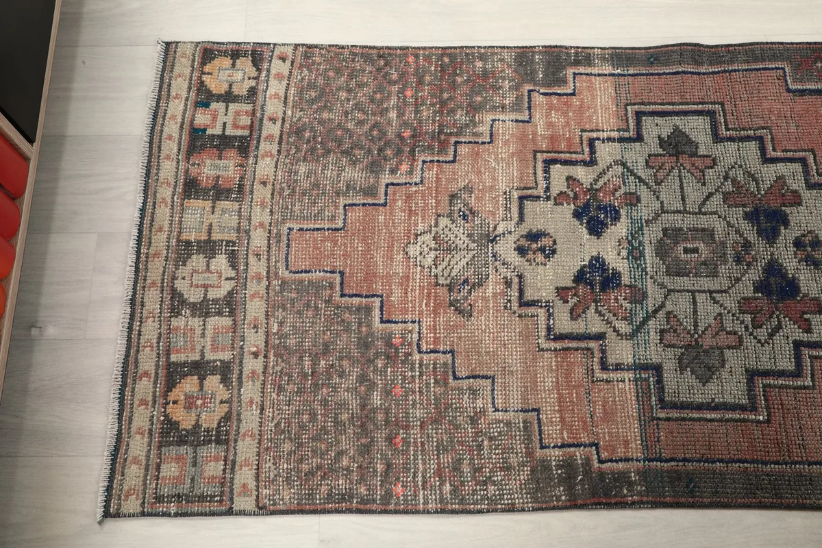 Angled view across the rug, revealing the distressed texture and color variations