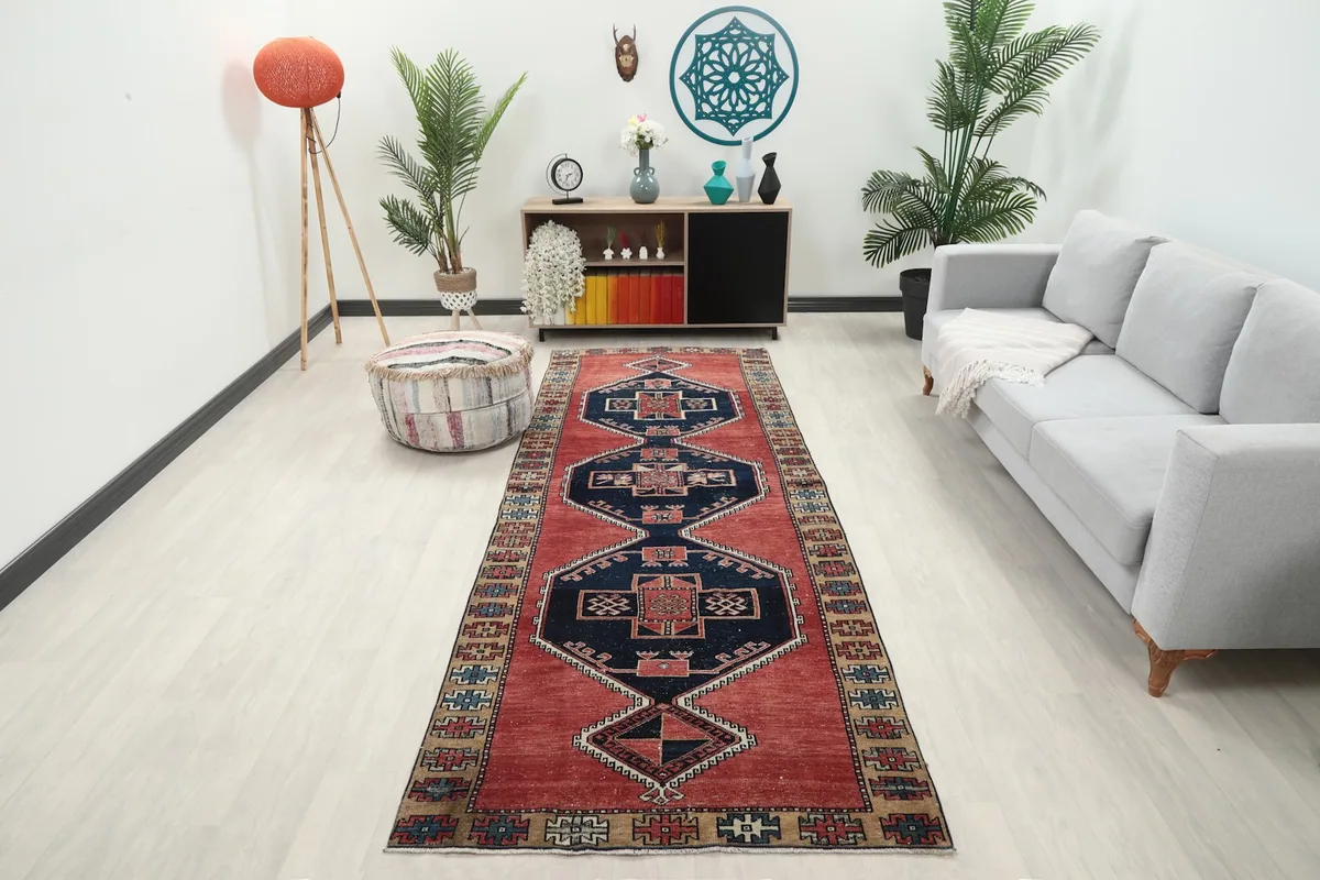 Anatolian runner rug laid in a room with light flooring and a gray sofa