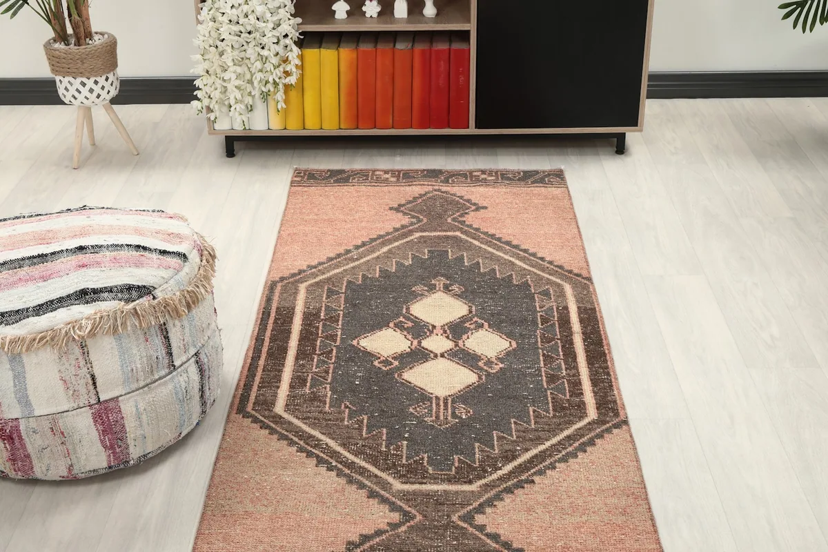 Overhead view of the runner rug in a room, highlighting the medallions and rose color