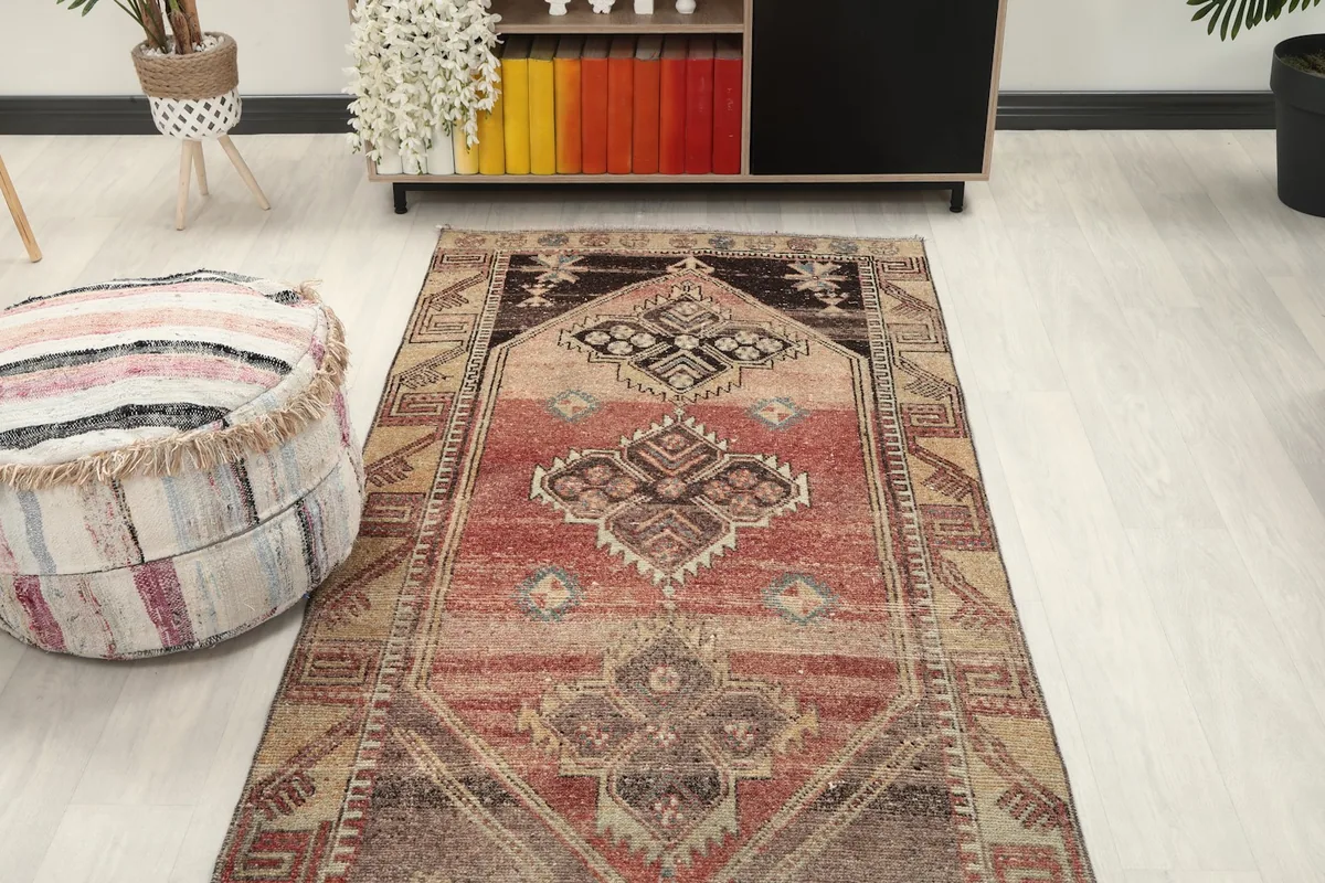 Overhead angle of the runner rug in a room, highlighting its length and design next to a pouf