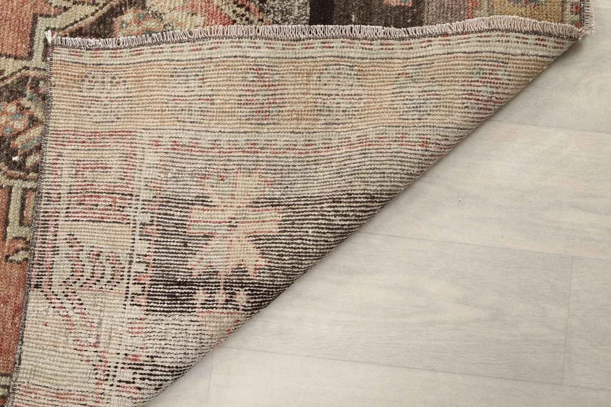 Underside of the runner rug, showing the tightly woven cotton foundation and knotting