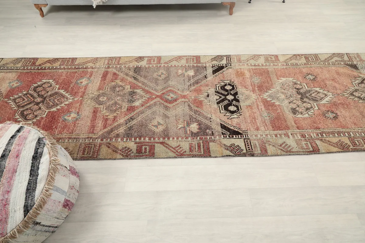 Overhead view of the entire runner rug, emphasizing its long, narrow shape and repeating patterns