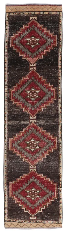 Full overhead view of the black, red, and gray geometric vintage Anatolian runner