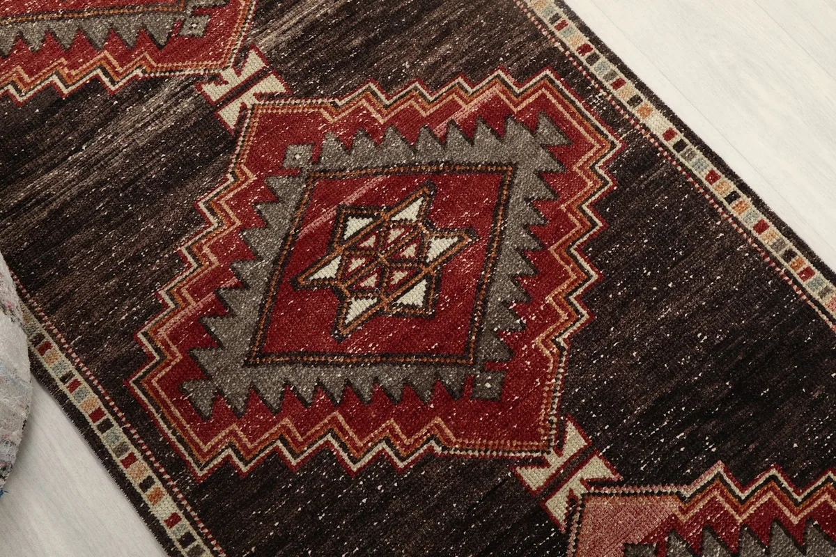 Angled view highlighting the central geometric patterns and border of the runner