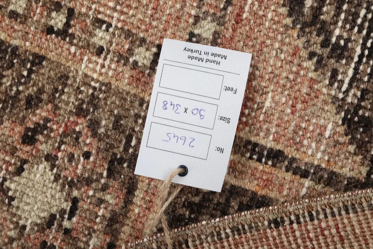 Close-up of the product tag indicating 'Hand Made in Turkey' and rug dimensions