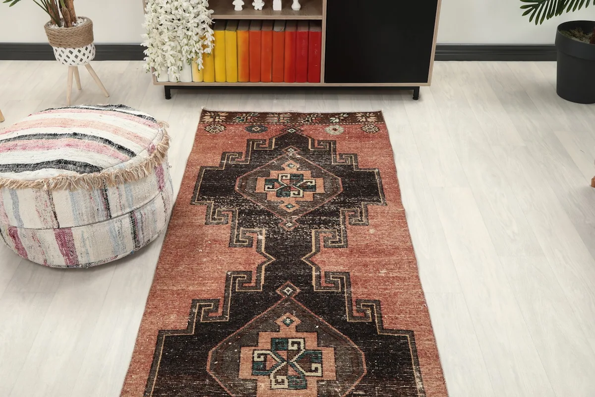 Overhead view of the vintage runner rug in a room, showing its placement in front of shelving
