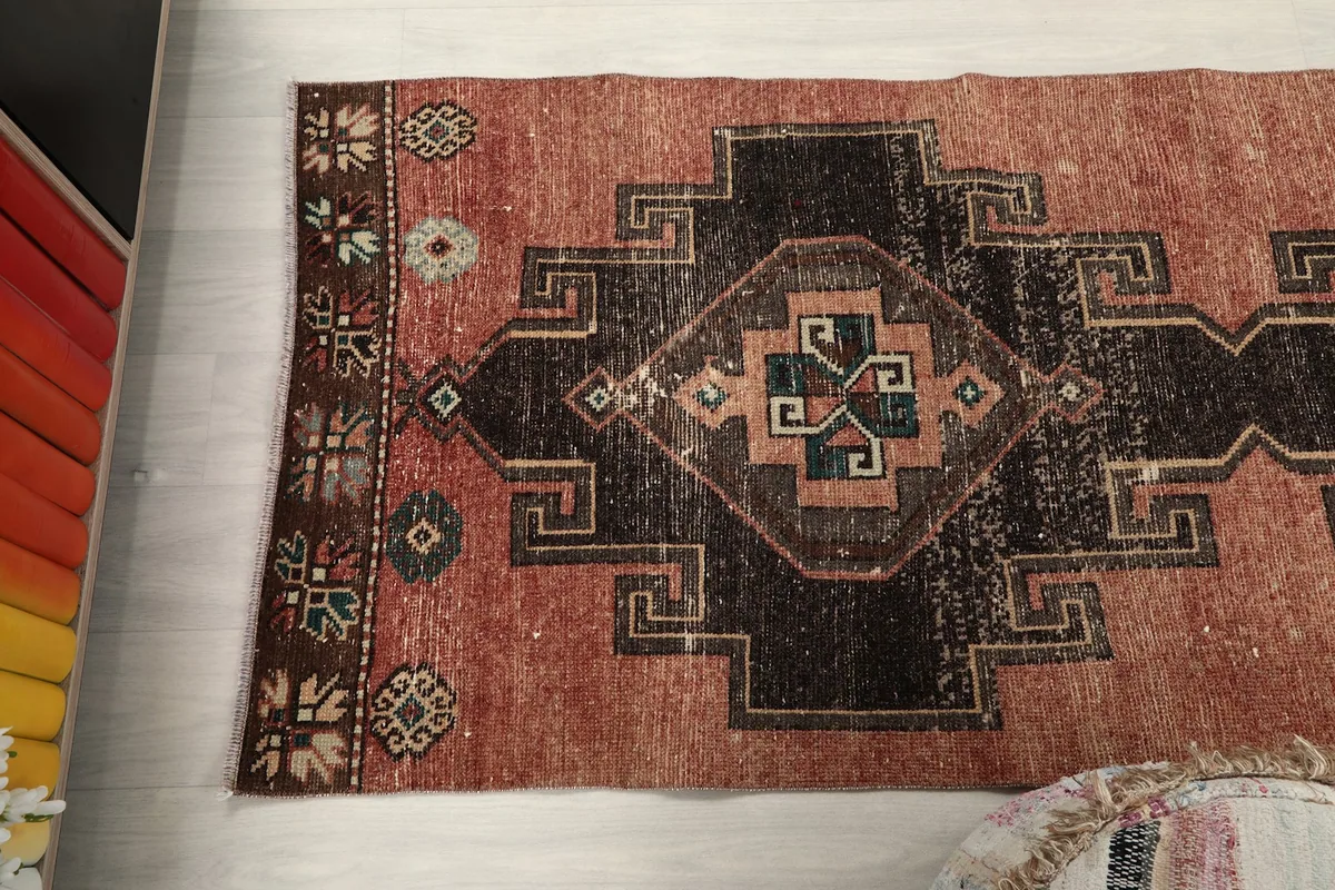 Overhead shot of one end of the runner rug, highlighting the geometric patterns and color variation