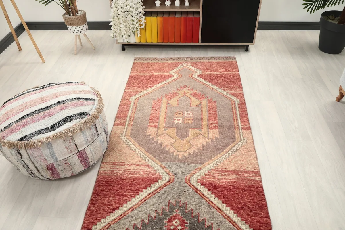 View of the runner rug from the opposite end, showcasing the lower geometric medallion