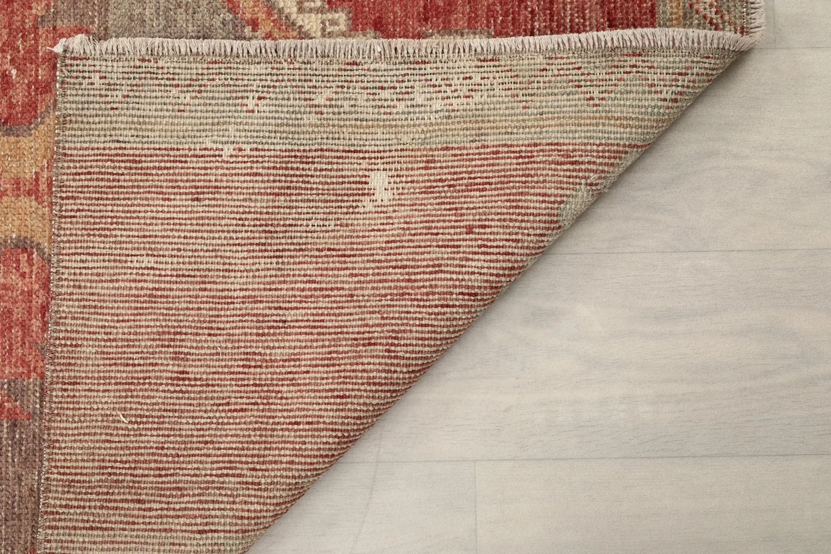 Underside of the rug, showing the reverse of the hand-knotted wool pile on cotton foundation