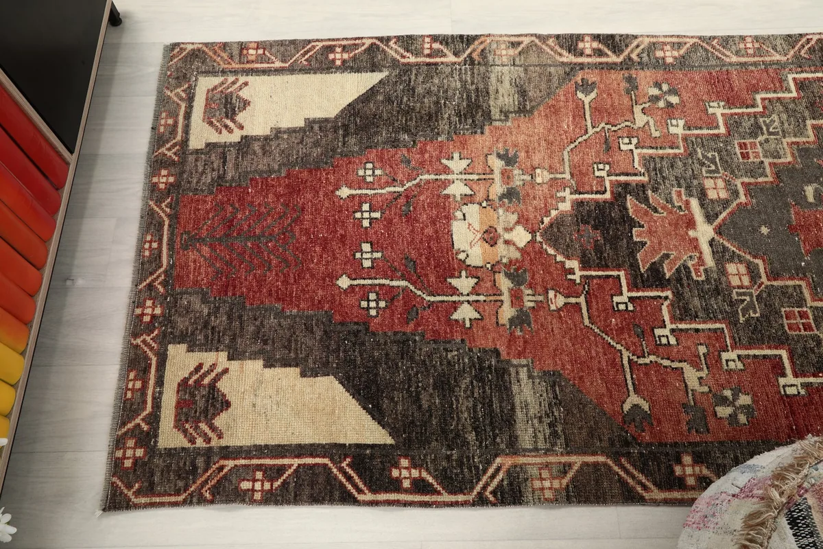 Angled view of the rug's top section, revealing the intricate patterns and color blend