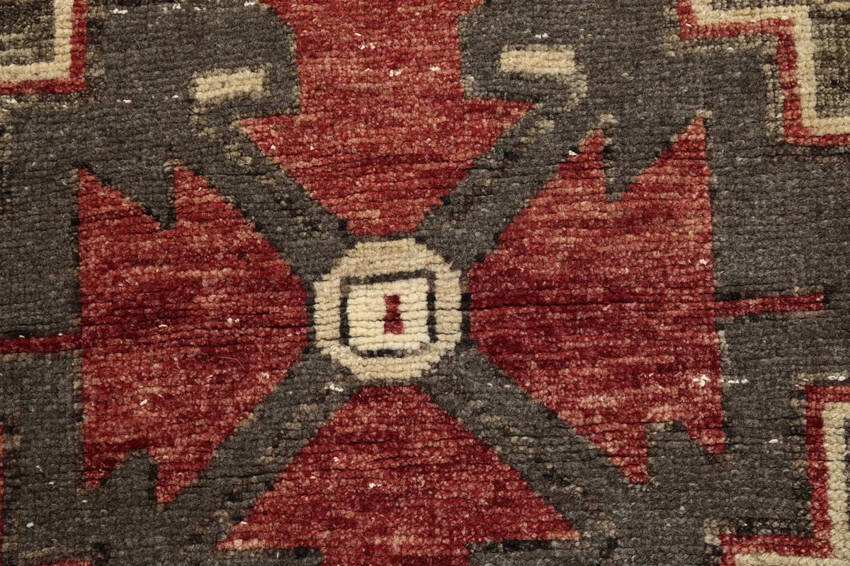 Macro detail of the hand-knotted wool pile, showcasing texture and color variation