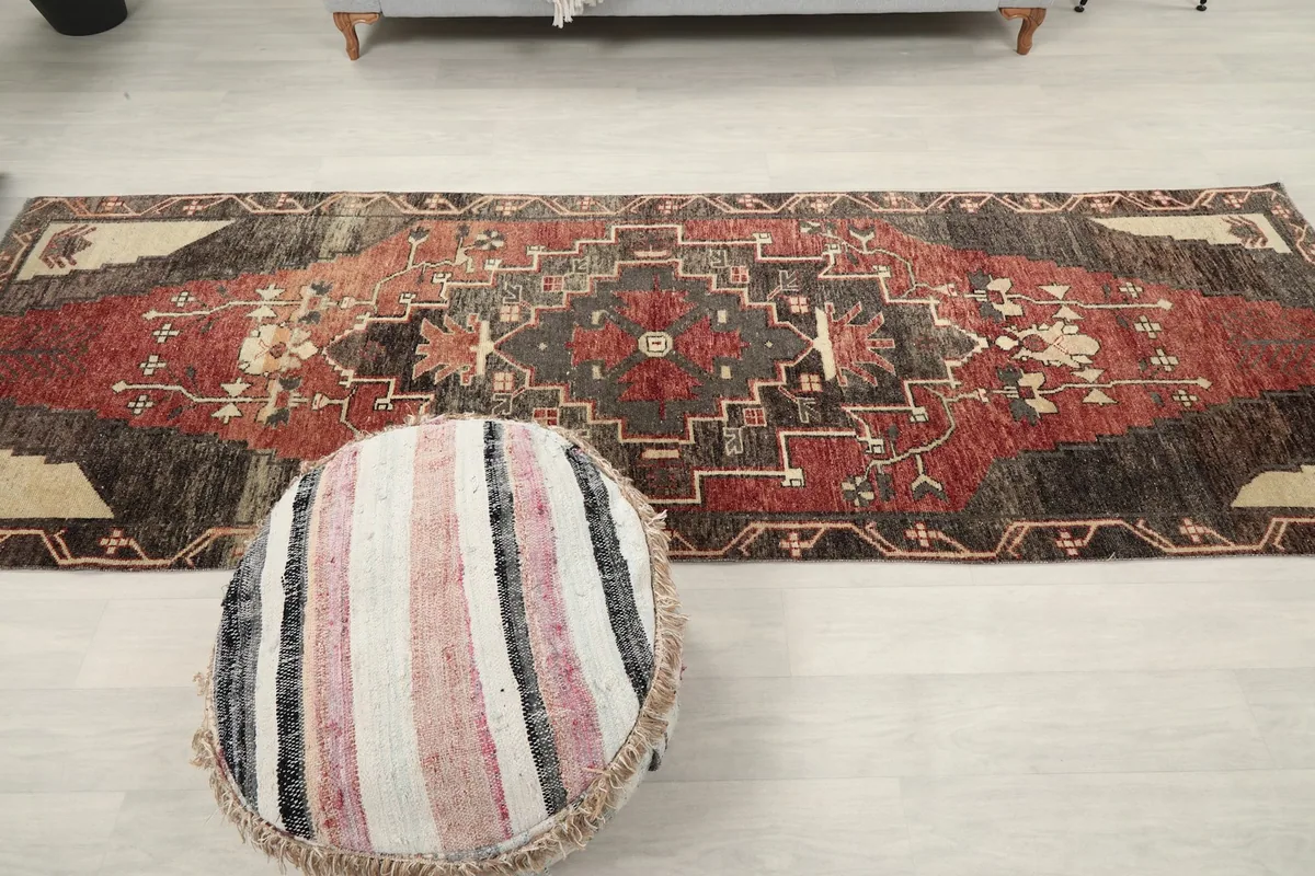 Full overhead shot of the runner rug with a pouf, emphasizing its overall design